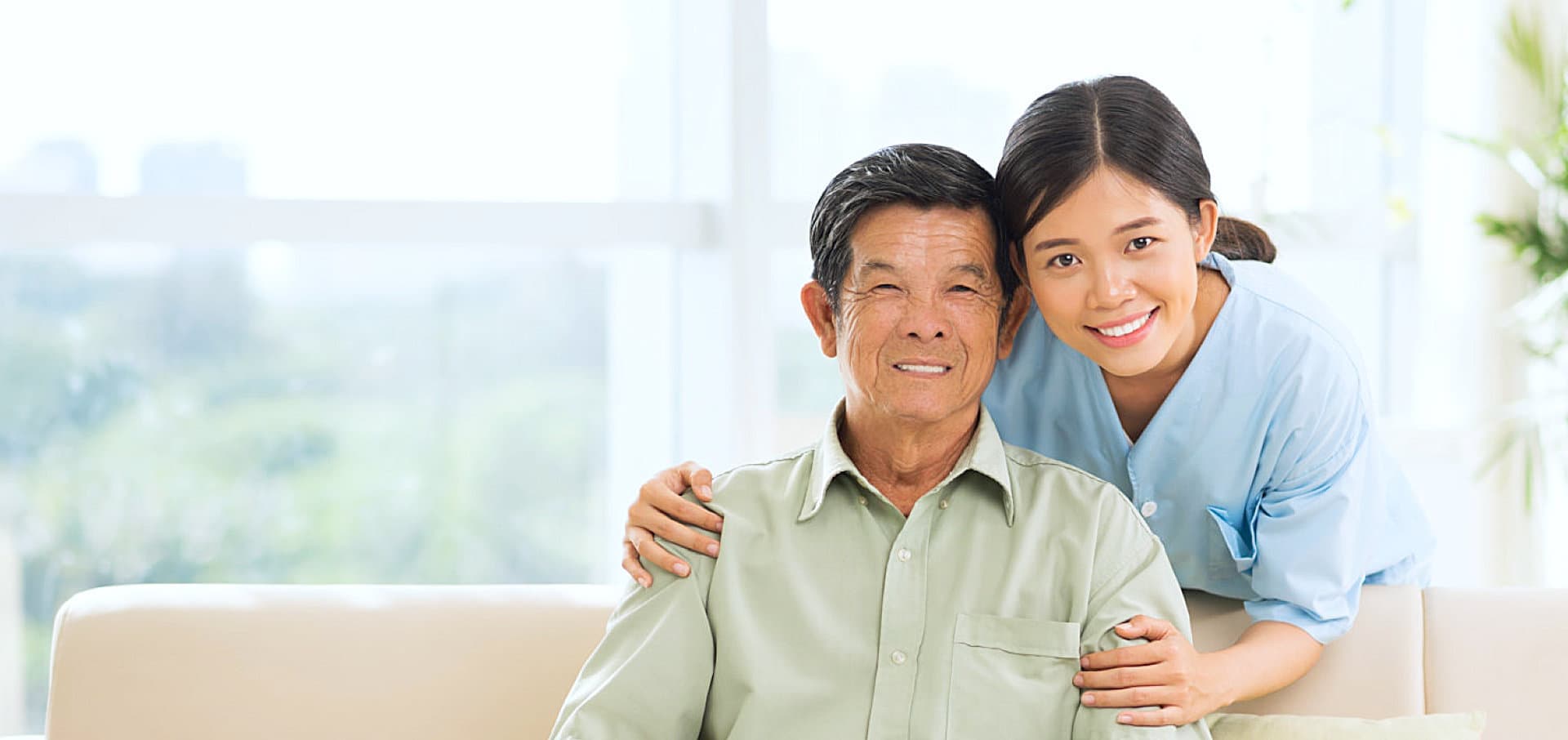 senior man and female caregiver smiling