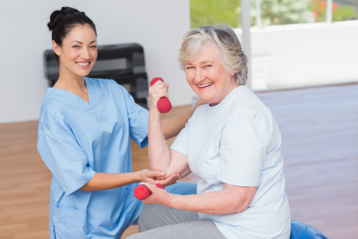 caregiver helping senior woman exercise