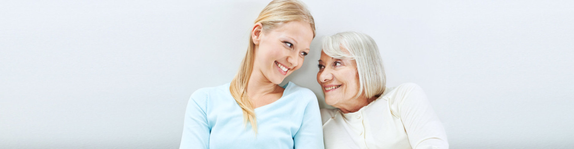female caregiver and senior woman looking at each other